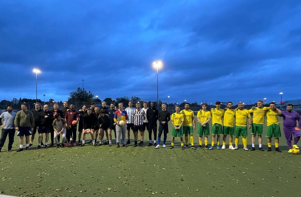 The players lining up beneath the floodlights