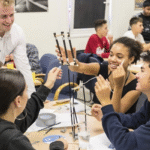 pupils gathered around and experimenting at a table