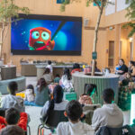 people watching a movie on a big screen