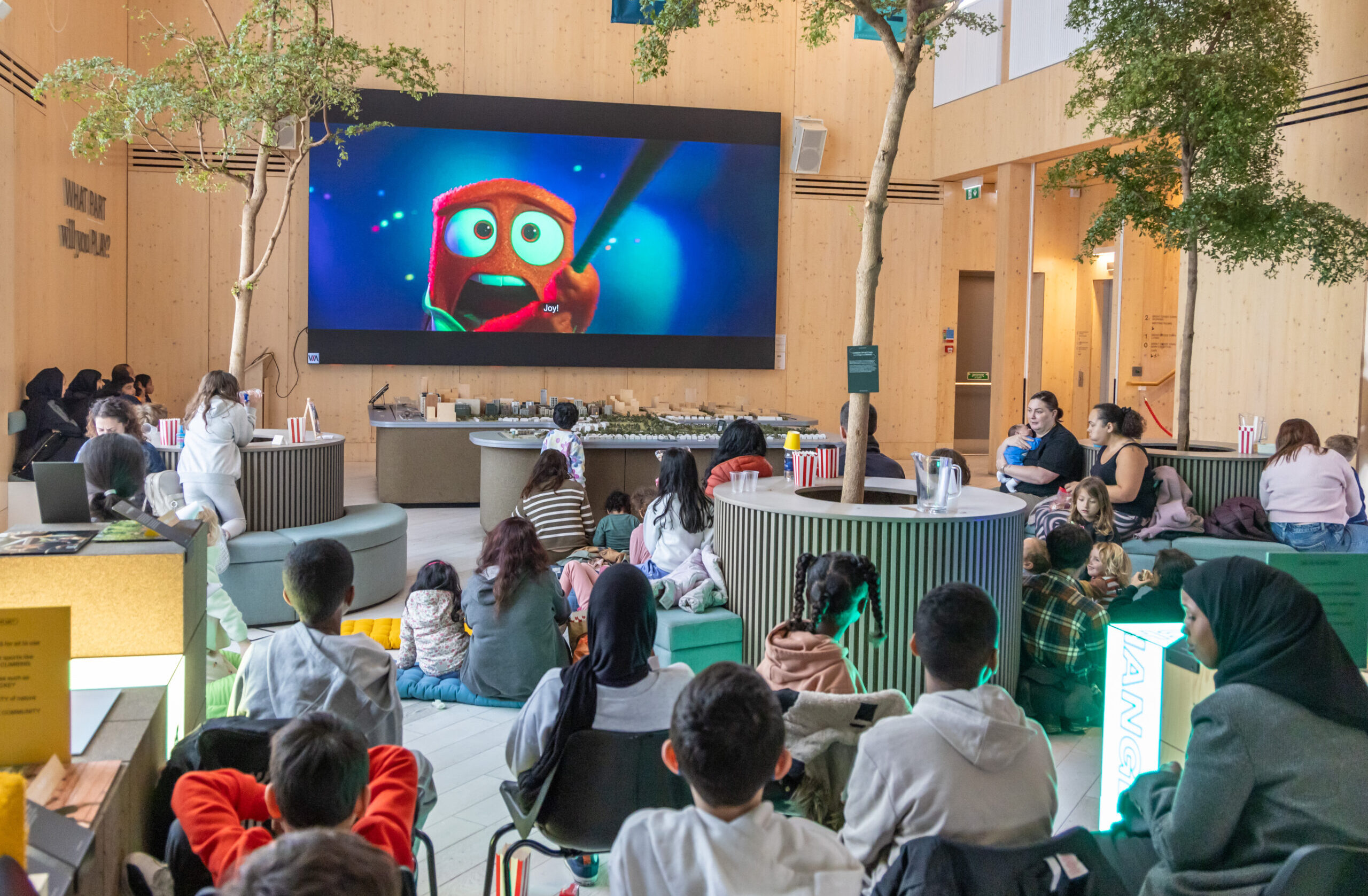 people watching a movie on a big screen