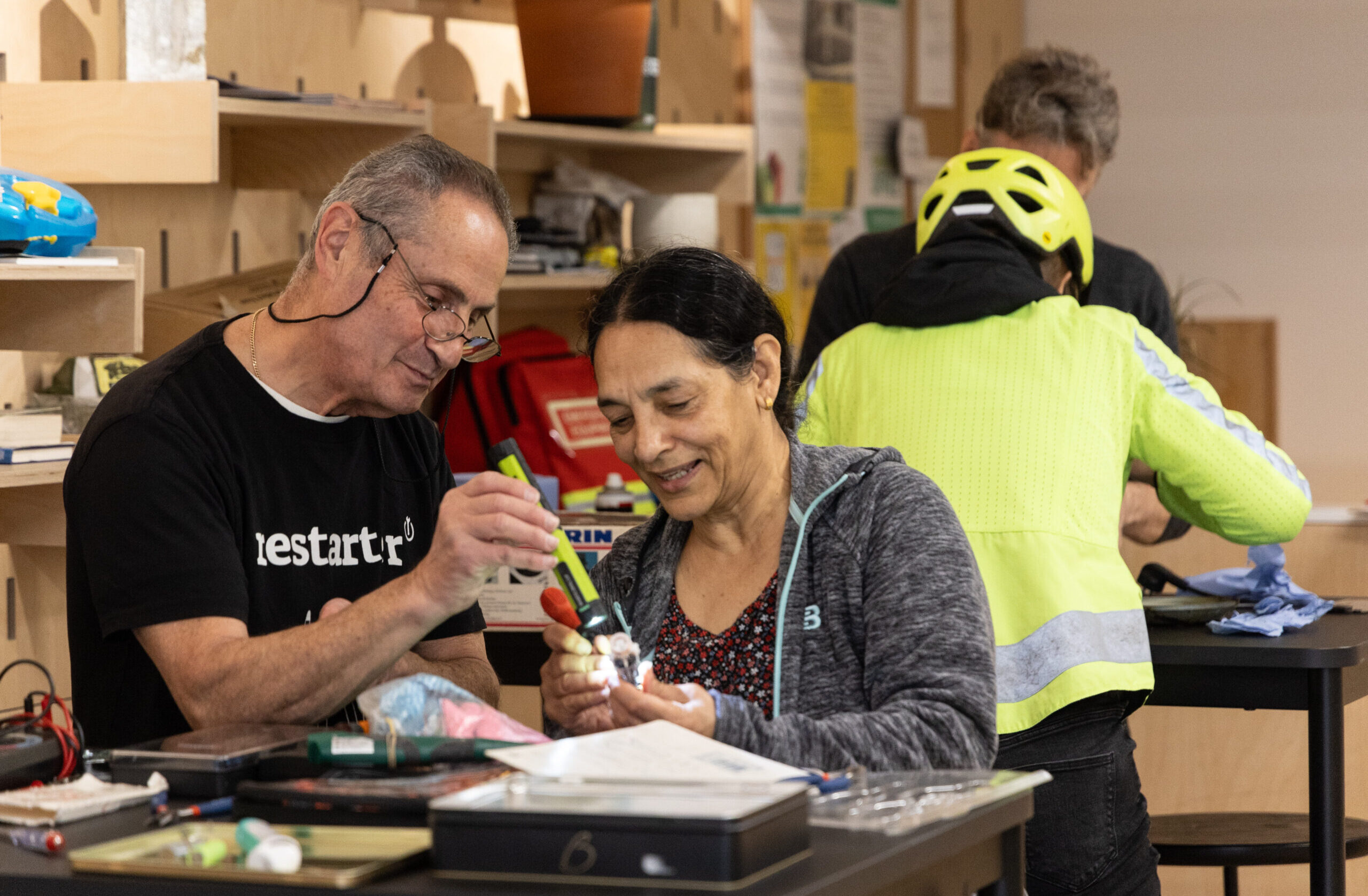 woman and man fixing an item