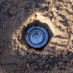 a metal capsule buried inside soil