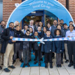 group of people assembled outside a store