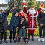 children posing with santa claus