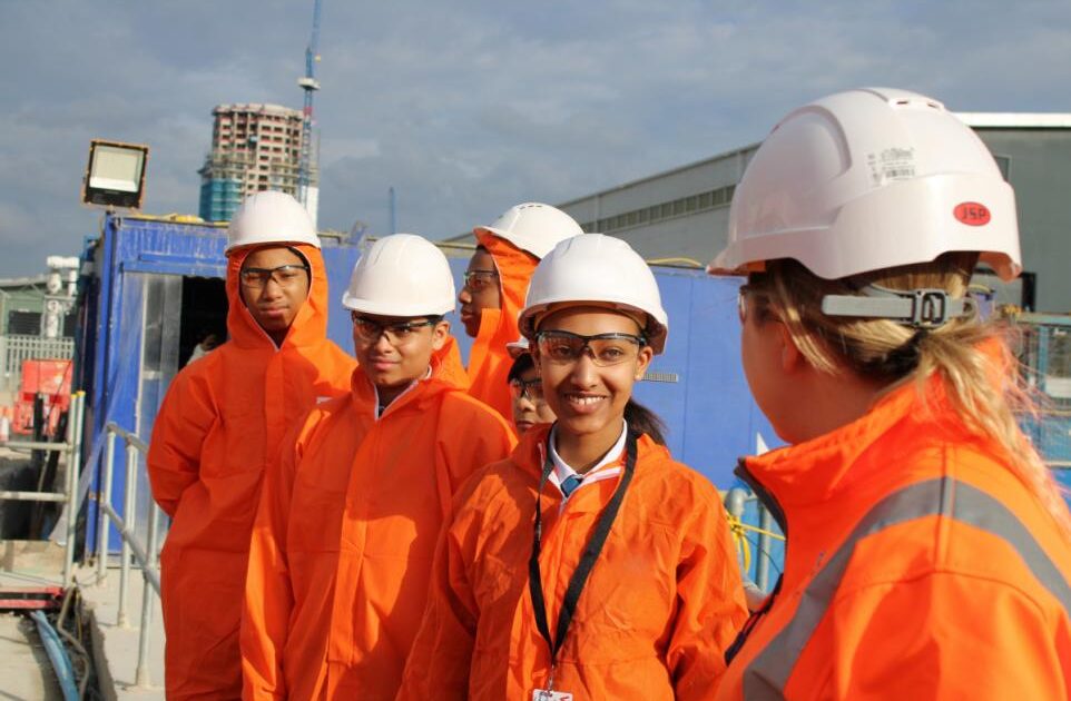 people in helmets and hi-vis