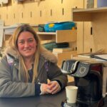 woman next to a coffee machine