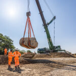 Crane delivering a boulder