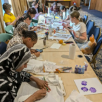 people colouring at a table