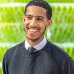 a boy smiling at the photo