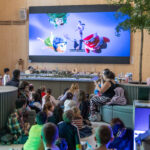 people watching a big screen